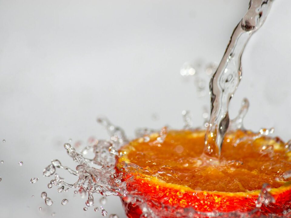Red Fruit Spilled With Water Time Laps Photo
